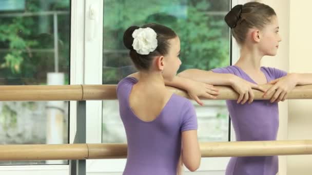 Pequeñas bailarinas sonrientes de pie en la barra . — Vídeo de stock