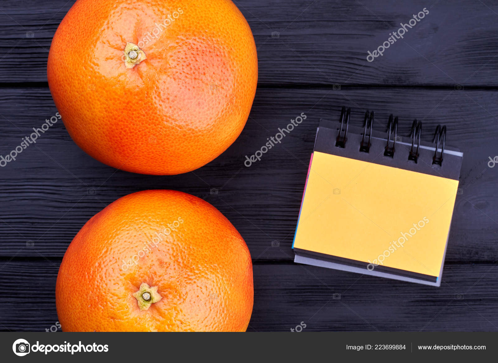 Two grapefruits and small binder notepad. Stock Photo by ©Denisfilm 223699884