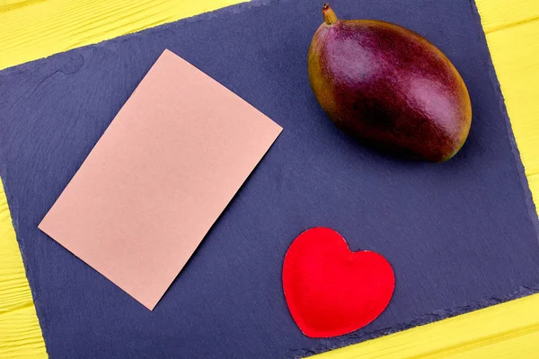 Mango, blank card and red heart.