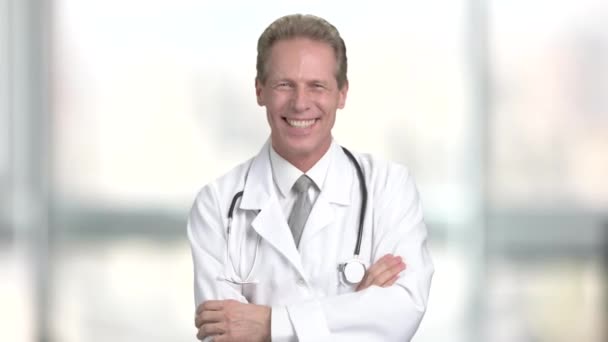 背景をぼかした写真で笑いながら成熟した医師. — ストック動画