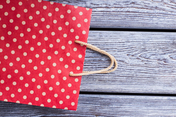 Red shopping bag with dots pattern.