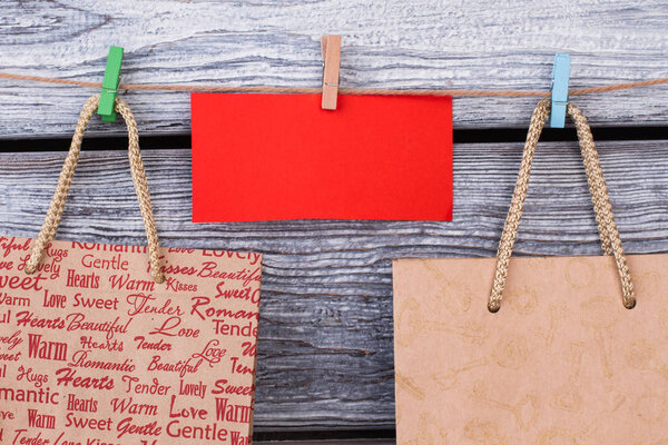 Paper carrier bags on wooden background.