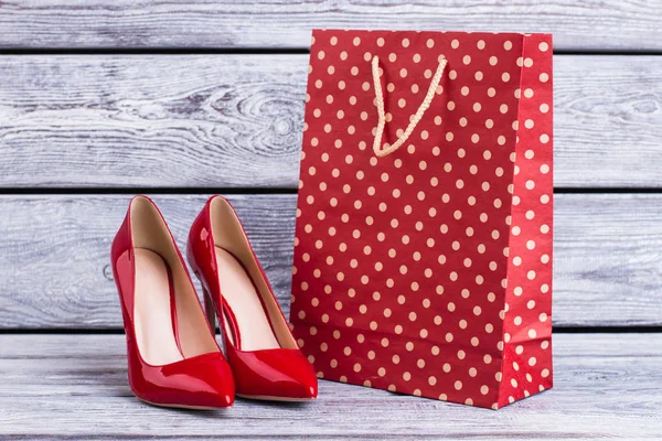 Female high heel shoes with shopping bag.