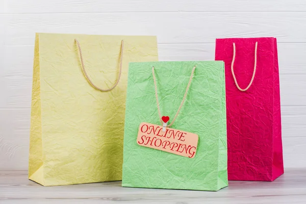 Multicolored shopping bags with handles. — Stock Photo, Image