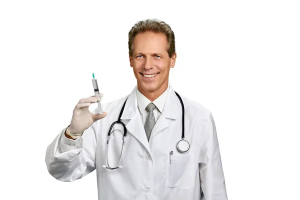 Portrait of cheerful male doctor with syringe. — Stock Photo, Image