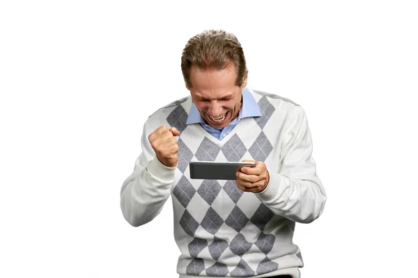 Excited man clenched fist holding smartphone. — Stock Photo, Image