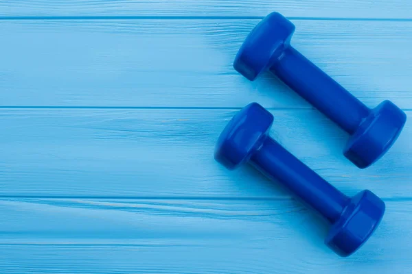 Blue dumbbells and copy space.