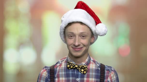 Portrait of teen boy in Christmas hat. — Stock Video