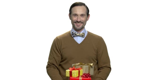 Smiling man giving gift boxes. — Stock Video