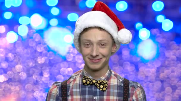 Christmas boy on blue bokeh background. — Stock Video