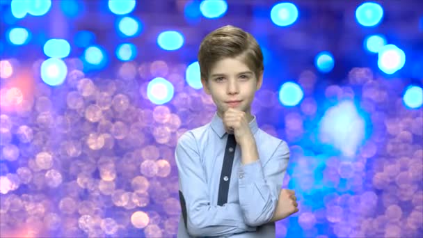 Retrato de niño guapo sobre fondo bokeh azul . — Vídeos de Stock