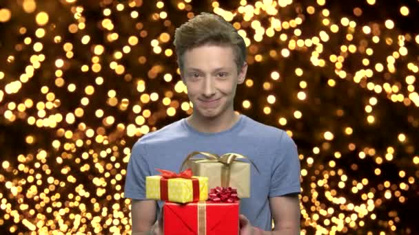 Christmas boy giving gift boxes. — Stock Video