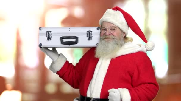 Smiling Santa holding silver case. — Stock Video