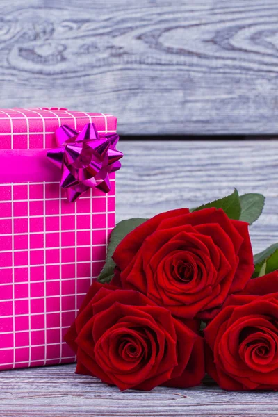 Blooming roses and gift box.