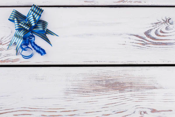 Festive blue gift bow with copy space.