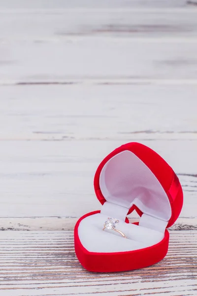 Red gift box with diamond ring.