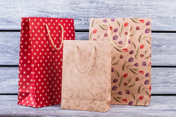 Set of shopping bags on wooden background. — Stock Photo, Image