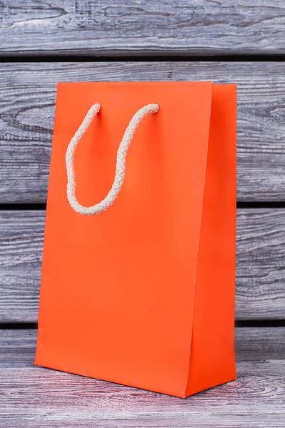 Orange paper shopping bag.