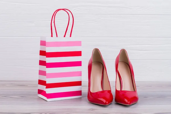 Red stilettos and paper gift bag.