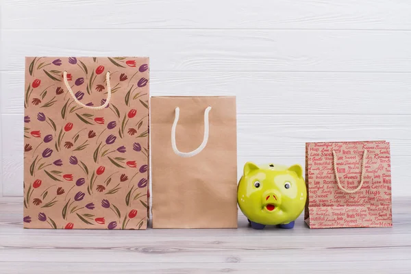 Kraft paper bags and piggy bank.