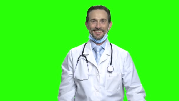 Mature doctor pointing at bottle of pills. — Stock Video