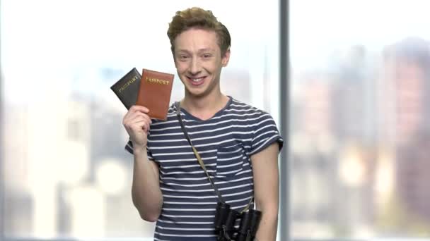 Young tourist boy showing passports. — Stock Video