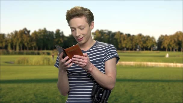 Satisfied boy tourist with passports. — Stock Video