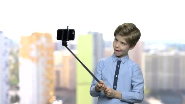 Child boy sticking out tongue while taking selfie. — Stock Video