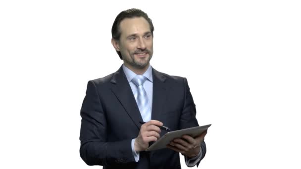 Attractive executive making a note on digital tablet. — Stock Video