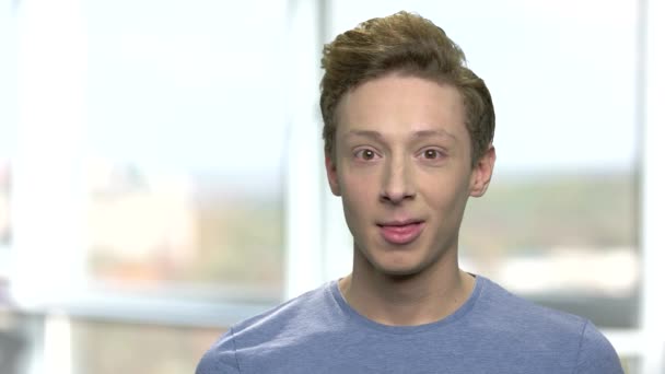 Handsome teenage boy looking at camera. — Stock Video