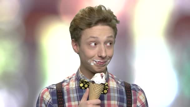 Legrační dospívající muž jíst zmrzlinu. — Stock video