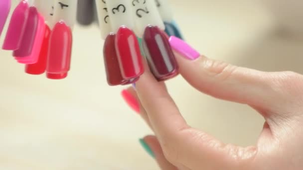 Nail color samples and manicured hand. — Stock Video