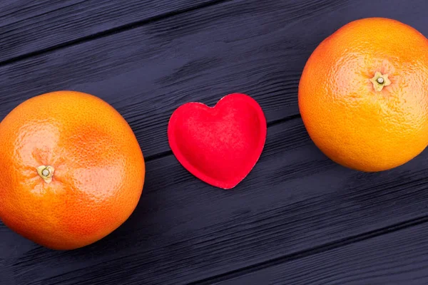 Dua buah jeruk dan hati merah . — Stok Foto