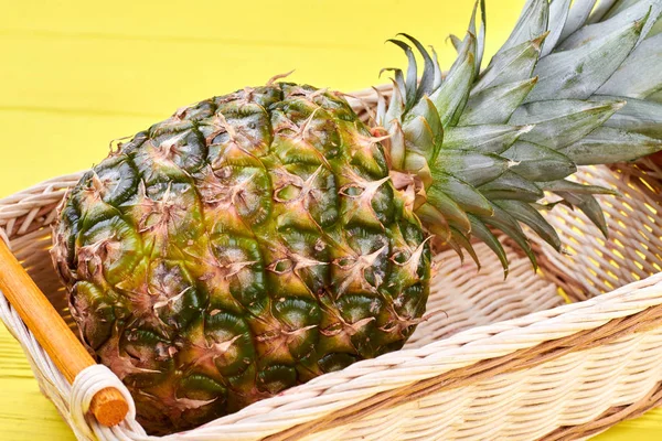 Big green pineapple in wicker basket. — Stock Photo, Image