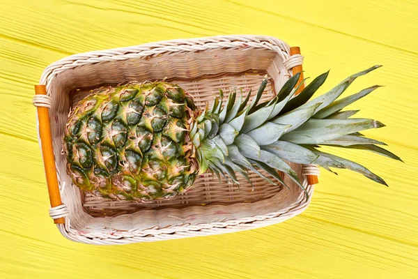 Pineapple in woven basket, top view. — Stock Photo, Image