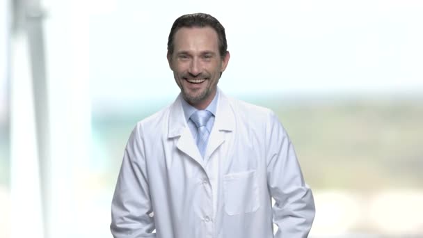 Man in white coat is laughing on blurred background. — Stock Footage Man in white coat is laughing on blurred background. Royalty Free Stock Footage