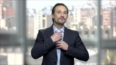 Onun kravat ayarlama çekici işadamı.