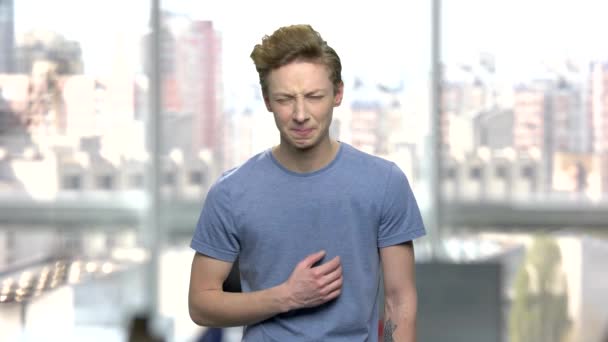 Portrait of teen boy with sudden stomach ache. — Stock Video