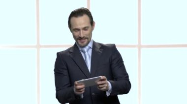 Akıllı telefon oyun olgun işadamı oynuyor.