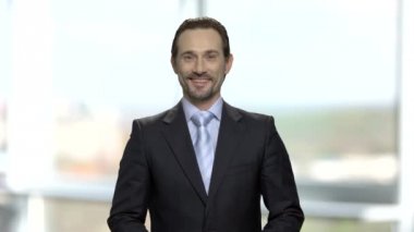 Sakallı yakışıklı işadamı kamera bakıyor.