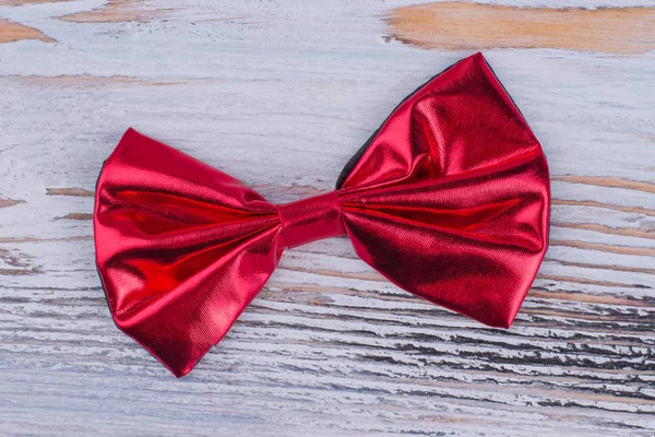 Red bow-tie on gray wooden background. — Stock Photo, Image
