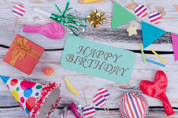 Happy Birthday background with colorful party supplies.