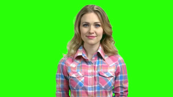 Young woman in checkered shirt looking at camera. — Stock Video