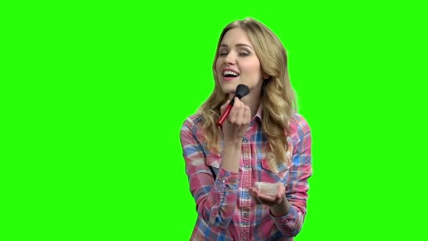 Junge hübsche Frau schminkt sich auf grünem Bildschirm. — Stockvideo
