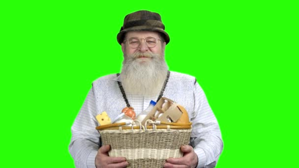 Cheerful farmer giving basket full of dairy products. — Stock Video