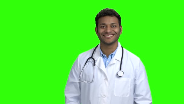 Guapo médico mirando a la cámara en la pantalla verde . — Vídeos de Stock