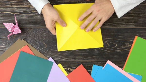 Man vouwen van papier als driehoek. — Stockfoto
