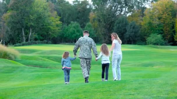 Familia feliz caminando lejos en campo de golf . — Vídeos de Stock