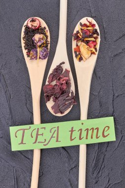 Wooden spoons with different types of dried tea.