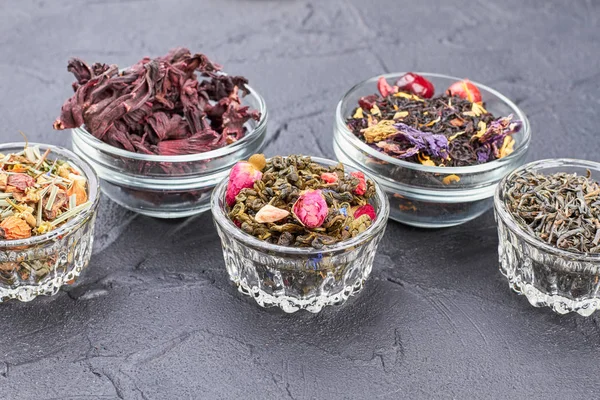Group of glass bowls with assorted dried teas. — Stock Photo, Image